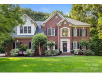 Beautiful two-story brick home with manicured landscaping and a welcoming entrance at 4389 Enchantment Cove Ln, Charlotte, NC 28216