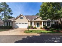 Charming ranch-style home with a two-car garage, lush lawn, mature landscaping, and inviting curb appeal at 4467 Antelope Ln, Charlotte, NC 28269
