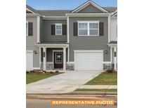 Charming townhome featuring a one car garage, covered entry, and neutral color palette at 6005 Jasmine Branch Rd, Charlotte, NC 28216