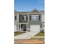 Charming gray townhome featuring a one-car garage and a covered front porch at 6005 Jasmine Branch Rd, Charlotte, NC 28216