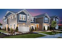 Charming new construction homes feature durable siding, manicured lawns, and attached two-car garages at 6423 Mallow Crossing Ln, Charlotte, NC 28213