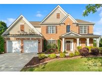 Charming two-story brick home with a manicured front yard and a two-car garage at 6430 Stirling Ln, Indian Land, SC 29707