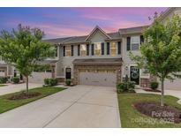 Charming townhome with a two-car garage, inviting entrance, and beautifully landscaped front yard at 138 Lanyard Dr # B, Mooresville, NC 28117