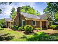 Charming brick home with a well-maintained lawn, chimney and a cozy, traditional architectural style at 1503 Brentwood Dr, Newton, NC 28658
