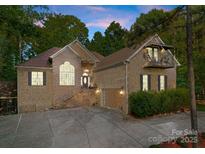 Charming brick home featuring an attached garage, balcony, well-manicured landscaping and a large front yard at 171 Secretariat Dr, Mooresville, NC 28117