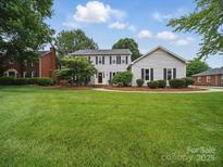 Charming two-story home with manicured lawn, tasteful landscaping and classic architectural details at 2223 Jon Chris Dr, Harrisburg, NC 28075