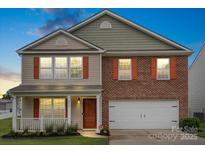 Charming two-story home featuring brick and siding, a covered front porch, and a two-car garage at 2515 Walnut Forest Dr, Charlotte, NC 28216