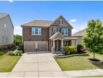 Beautiful two-story home featuring a two-car garage, manicured lawn and stone-accented facade at 2835 Berkhamstead Cir, Concord, NC 28027