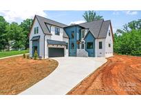 A modern two-story home featuring a gray roof, mixed siding, and a concrete driveway at 3078 Mountain Creek Dr, Sherrills Ford, NC 28673