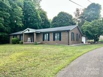 Charming brick ranch home with a well-manicured lawn and inviting front porch at 35 Caldwell Dr, Taylorsville, NC 28681