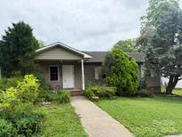 Charming single story home with a welcoming walkway and lush, mature landscaping at 405 Jose St, Shelby, NC 28150
