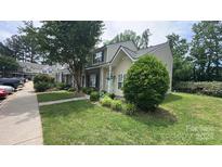Charming townhome features a well-manicured lawn and traditional siding at 7504 Petrea Ln, Charlotte, NC 28227
