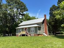 Charming exterior of this single Gathering home features a lush green lawn and a welcoming covered front porch at 9401 Gold Hill Rd, Mount Pleasant, NC 28124