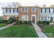 A charming townhome featuring a brick facade, well-maintained landscaping, and a welcoming front entrance at 9464 Lexington Cir # B, Charlotte, NC 28213