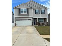 Two-story home featuring gray siding, dark shutters, a two-car garage, and a well-maintained front yard at 9639 Margrave Dr # 252, Gastonia, NC 28056