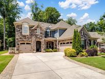 Beautiful stone and siding home with well-manicured landscaping and a spacious driveway at 1006 Wellington Ave, Indian Land, SC 29707
