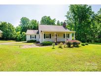 Charming single-story home with a well-manicured lawn and a covered front porch at 1276 Beechwood Dr, Newton, NC 28658