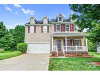Charming two-story home featuring a front porch, manicured lawn, and attached garage at 1503 Stoney Ct, York, SC 29745