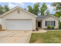 Charming single-story home features a two-car garage and manicured front lawn, presenting curb appeal at 1776 Baylor Dr, Rock Hill, SC 29732