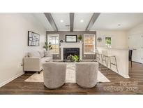 Inviting living room featuring a cozy fireplace, beamed ceilings, and a stylish seating arrangement at 1776 Baylor Dr, Rock Hill, SC 29732