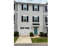 Charming two-story townhome with a garage, teal front door, and manicured front yard at 2037 Langer St, Charlotte, NC 28214