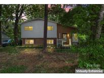Charming home featuring a combination of brick and siding, complemented by lush surrounding trees at 2255 Milton Rd, Charlotte, NC 28215