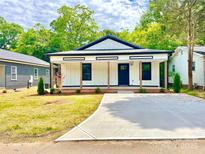 Charming newly renovated home featuring a covered front porch and fresh landscaping at 253 Hall Nw Ave, Concord, NC 28027