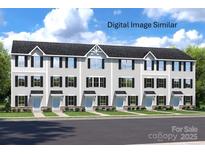 Inviting townhouse exterior with white siding, black shutters, and well-maintained landscaping at 3233 Dannelly Towns Aly # 1002C, Charlotte, NC 28208