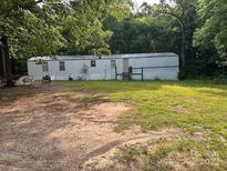 Wide exterior view of a home with lawn and mature trees at 3234 Legend Rd, Lancaster, SC 29720