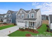 Charming two-story home with stone accents, a white garage door, landscaped yard, and craftsman architecture at 32616 Millingport Rd # 7144, New London, NC 28127