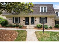 Charming brick townhome featuring a well-manicured lawn and classic architectural details at 3528 Colony Rd # A, Charlotte, NC 28211