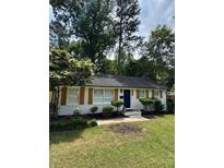 Charming single-story home with a manicured lawn and a classic brick facade at 3700 Denson Pl, Charlotte, NC 28215