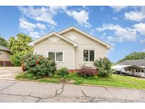 Charming home with a well-maintained lawn and inviting curb appeal under a partly cloudy sky at 380 Woodlawn Ave, Cramerton, NC 28032