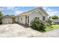 Charming single-story home with vinyl siding, well-maintained lawn, and separate garage at 380 Woodlawn Ave, Cramerton, NC 28032