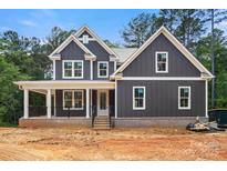 New construction featuring a covered front porch, board and batten siding, and professionally designed trim at 4315 Palm Dr, Denver, NC 28037