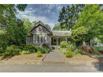 Charming home with manicured landscaping, stone walkway, and inviting front porch at 504 S Hayne St, Monroe, NC 28112