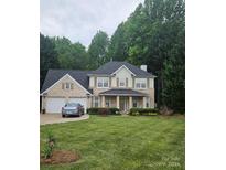 Charming two-story brick home with a well-manicured lawn and attached two-car garage at 5625 Linda Vista Ln, Charlotte, NC 28216