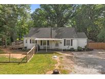 Charming single-Gathering home with a fenced yard and deck in a lush, green setting, offering comfortable outdoor living at 800 Woodlawn St, Belmont, NC 28012