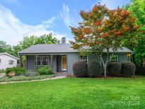 Charming home with a well-manicured lawn, mature landscaping, and inviting curb appeal at 827 Fairbanks Rd, Charlotte, NC 28210