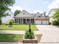 Charming brick home with a manicured front lawn, inviting entrance, and attached two car garage at 8605 Soaring Eagle Ln, Waxhaw, NC 28173