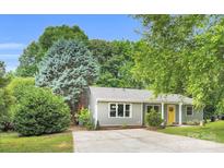 Charming single-story home with a well-manicured lawn, driveway, and light-colored siding at 9826 Meringue Pl, Charlotte, NC 28270