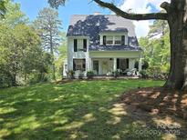 Charming two-story home with a covered front porch and a spacious, well-manicured front yard at 1051 14Th Avenue Nw Dr, Hickory, NC 28601