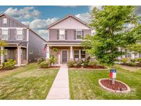 Charming two-story home with landscaped yard and inviting front porch in a suburban neighborhood at 11951 Old Statesville Rd, Huntersville, NC 28078