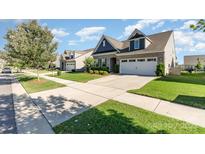 Charming home with manicured lawn, long driveway, and attached two-car garage at 13338 Blanton Dr, Huntersville, NC 28078