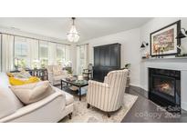 Comfortable living room with a fireplace, plush seating, and neutral decor at 13338 Blanton Dr, Huntersville, NC 28078