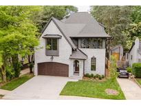 Charming two-story painted brick home with a well-manicured lawn and a stylish brown garage door at 1625 Club Rd, Charlotte, NC 28205
