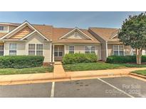 Inviting townhome with manicured landscaping and assigned parking space in a well-maintained community at 1890 Sandal Brook Rd, Fort Mill, SC 29707