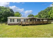 Charming home featuring a large wooden deck perfect for outdoor relaxation and entertaining at 2021 Beamguard Rd, Clover, SC 29710