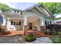 Charming front exterior with a brick porch and rocking chairs at 2412 Chesterfield Ave, Charlotte, NC 28205