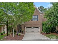 Charming brick home features a two-car garage and well-manicured landscaping, creating great curb appeal at 4311 Sheffield Park Ave, Charlotte, NC 28211